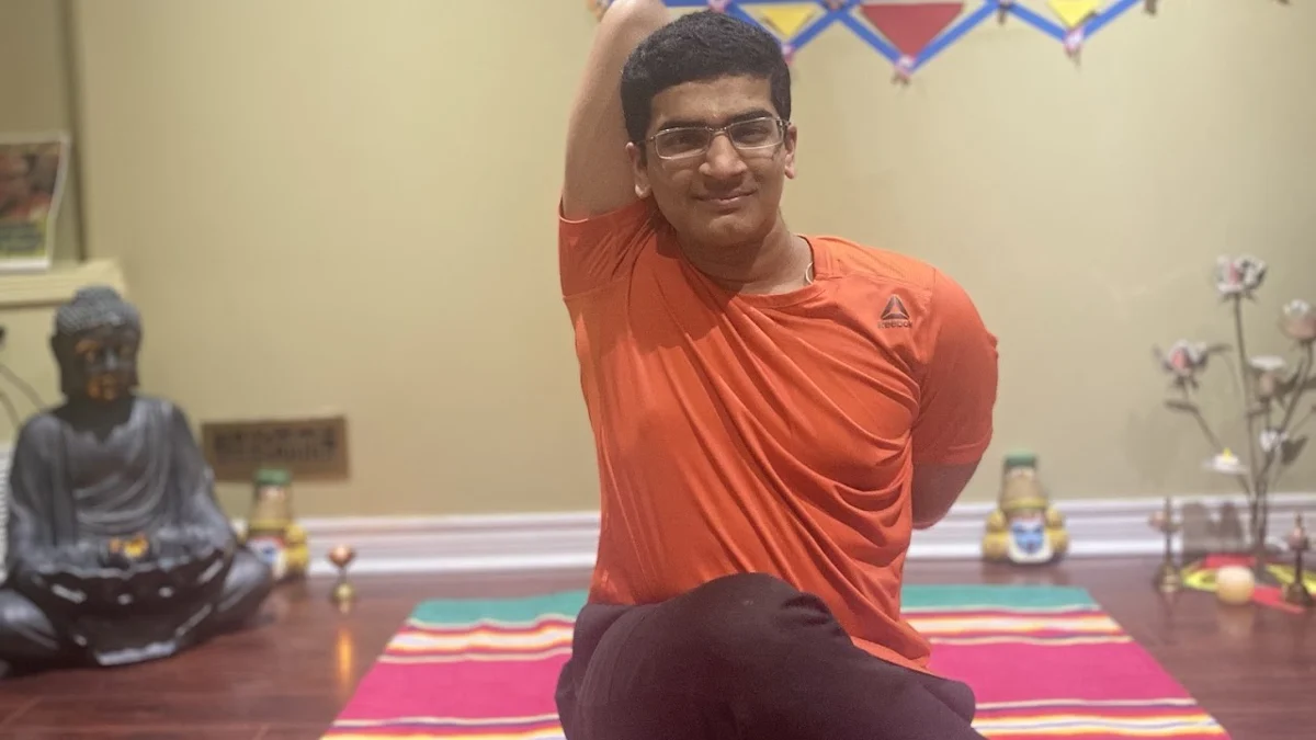 Udbhav demonstrating a seated yoga pose