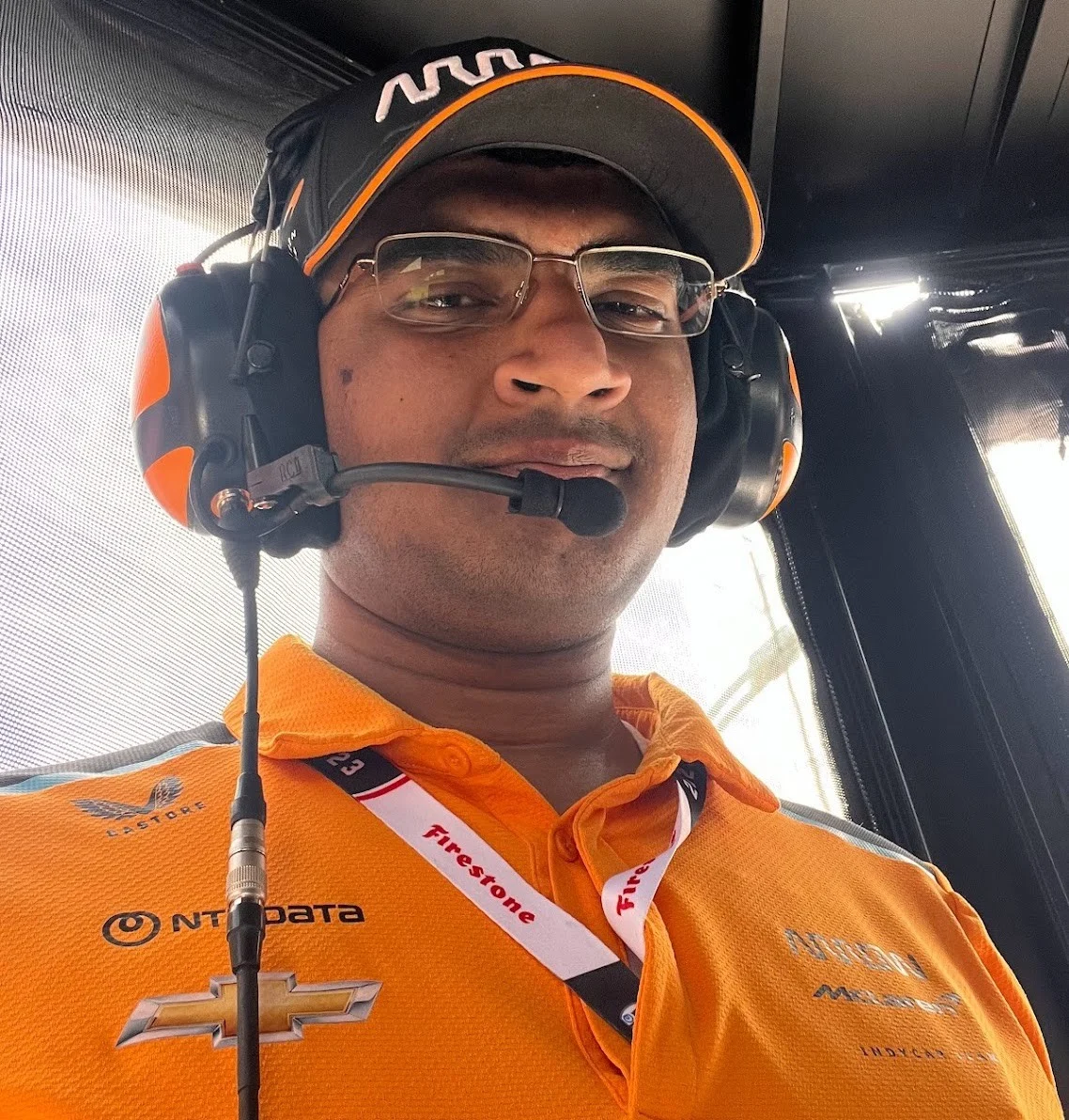 Udbhav Ram in Arrow McLaren team clothing and a headset